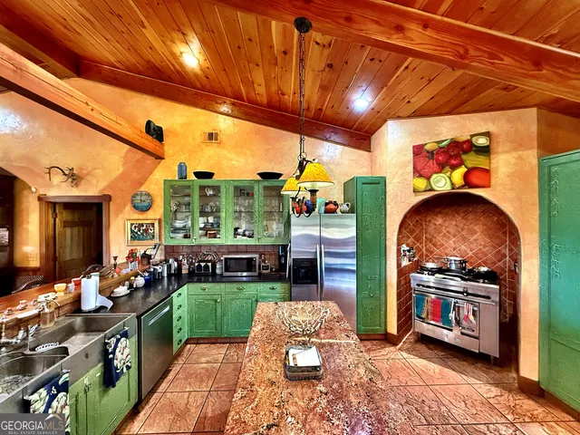 a bathroom with a granite countertop toilet a sink and a mirror