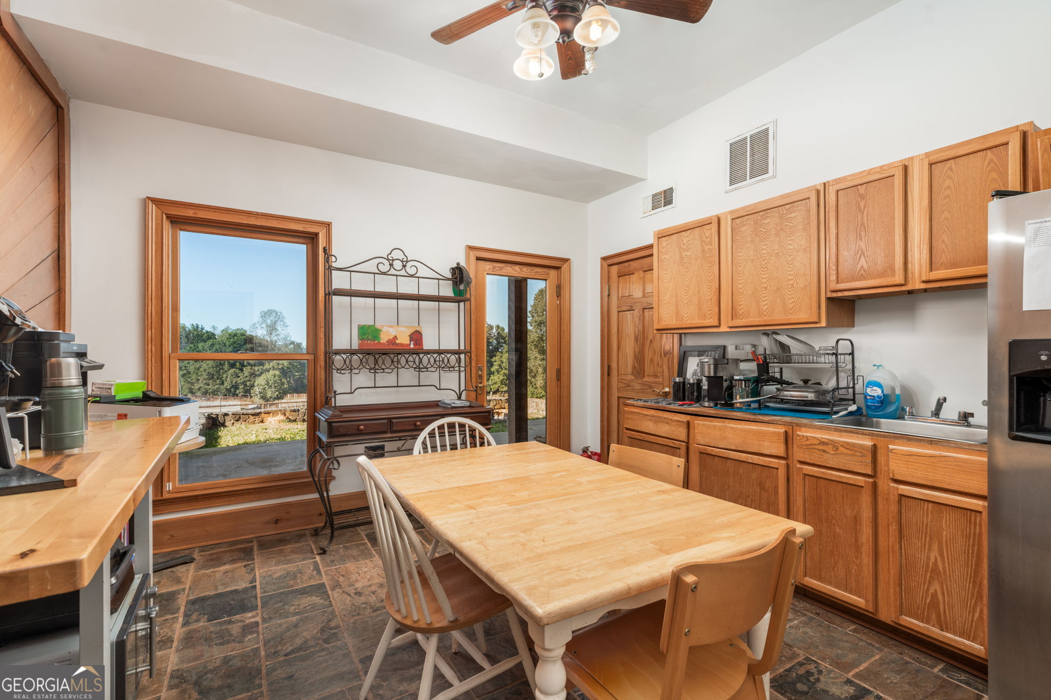 120 Torbet Road Forsyth, GA 31029 - Photo 78 of 118 a kitchen with a table chairs sink and cabinets