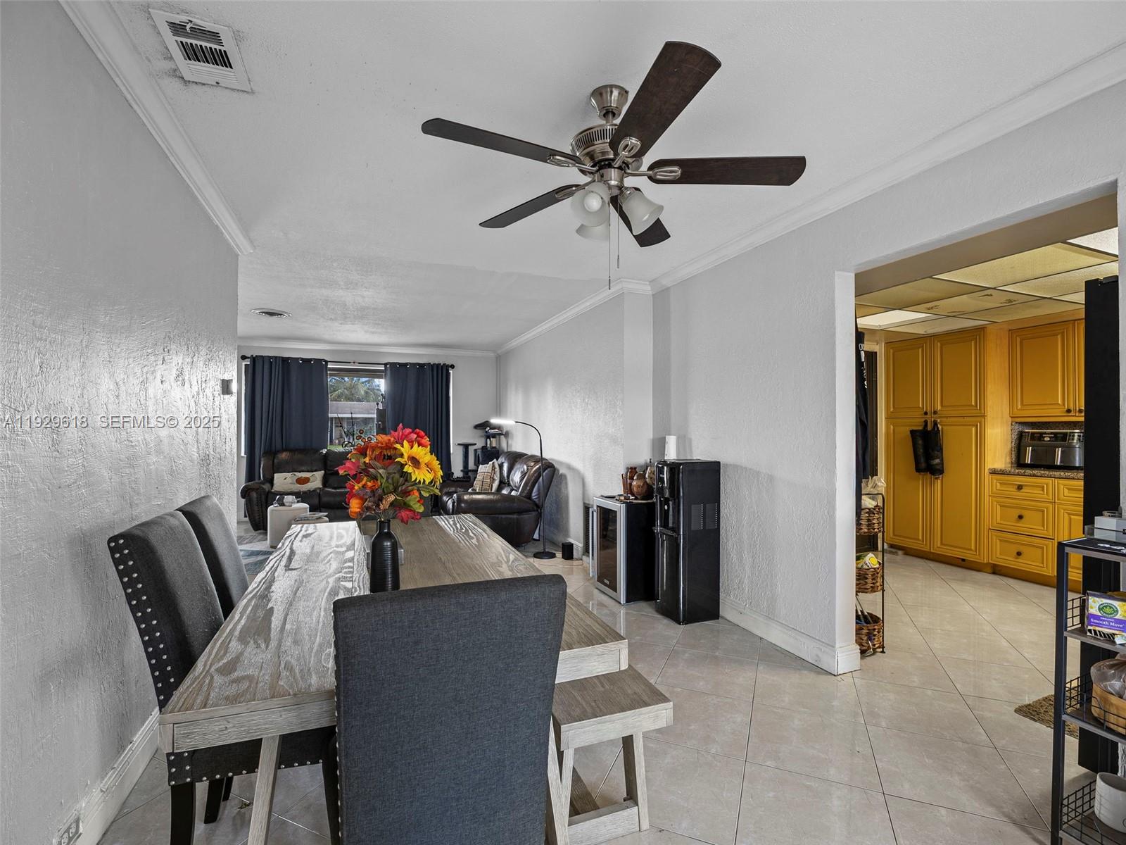 4461 Northwest 6th Street Plantation, FL 33317 - Photo 12 of 30 a view of a dining room with furniture and a chandelier