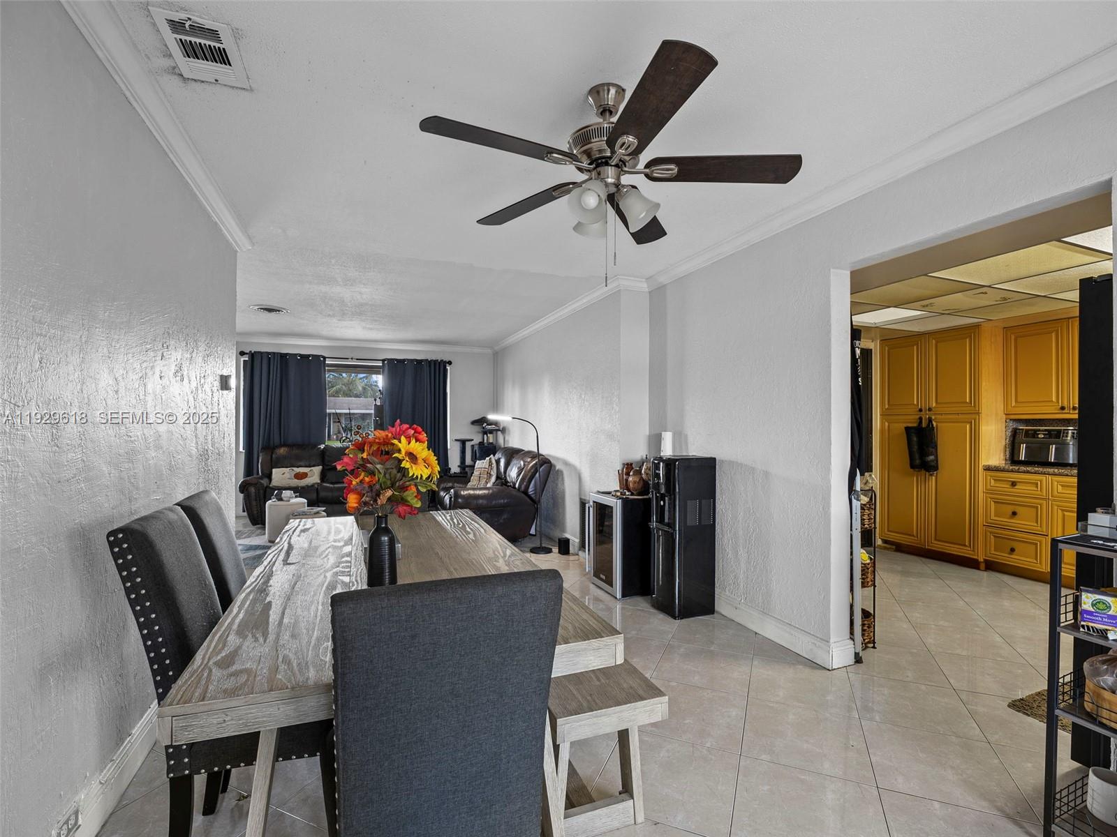 4461 Northwest 6th Street Plantation, FL 33317 - Photo 13 of 30 a view of a dining room with furniture and a chandelier