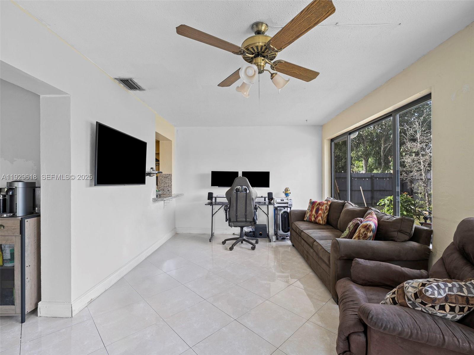 4461 Northwest 6th Street Plantation, FL 33317 - Photo 14 of 30 a living room with furniture and a flat screen tv