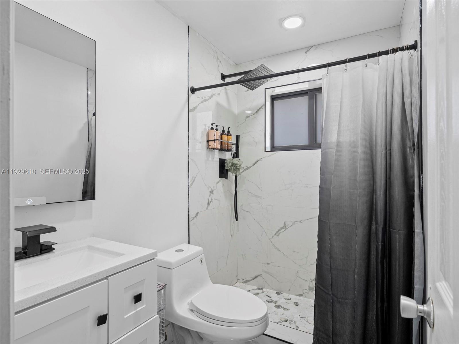 4461 Northwest 6th Street Plantation, FL 33317 - Photo 16 of 30 a bathroom with a sink a toilet and shower