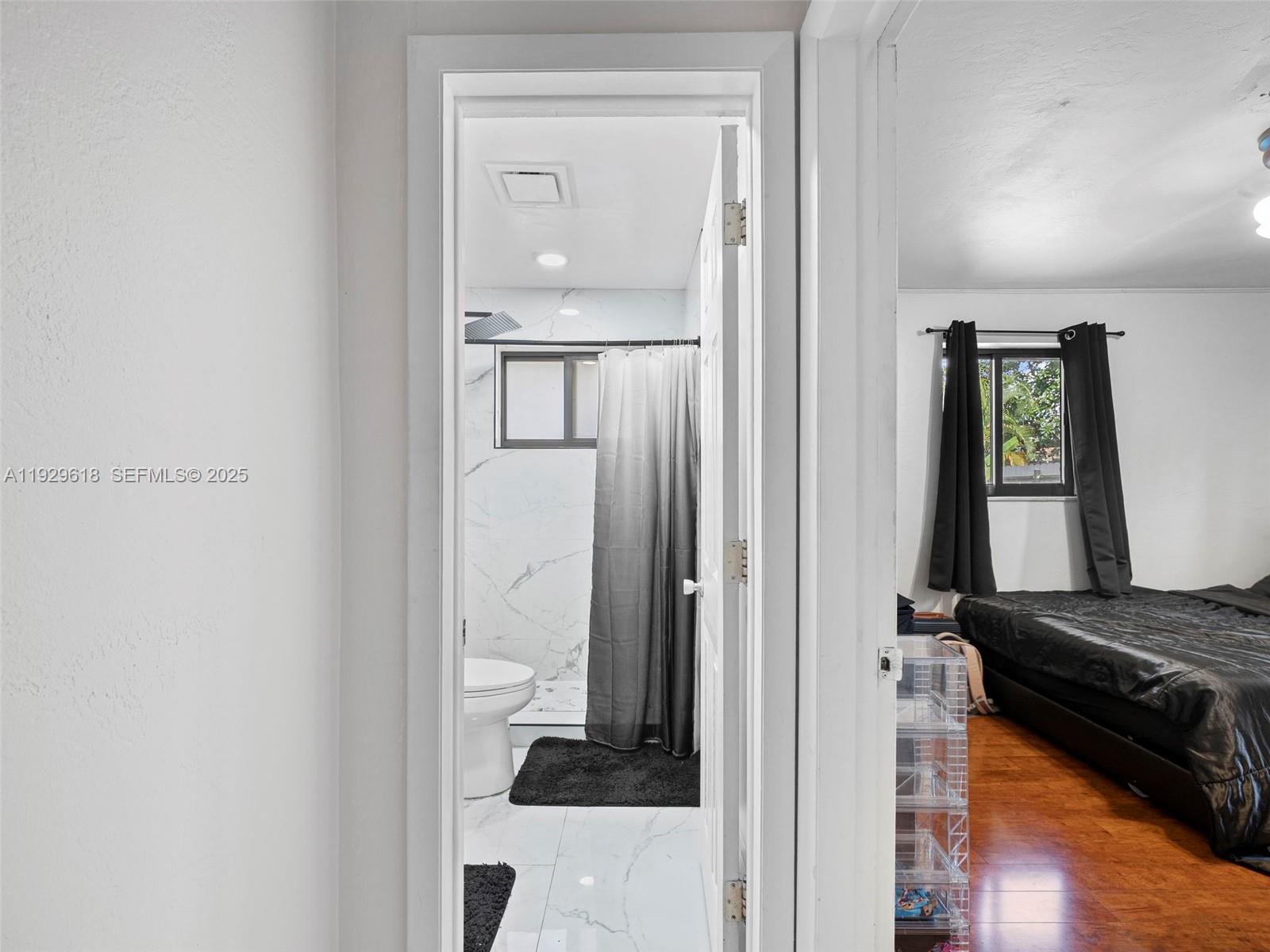 4461 Northwest 6th Street Plantation, FL 33317 - Photo 19 of 30 a bedroom with a bed and a mirror