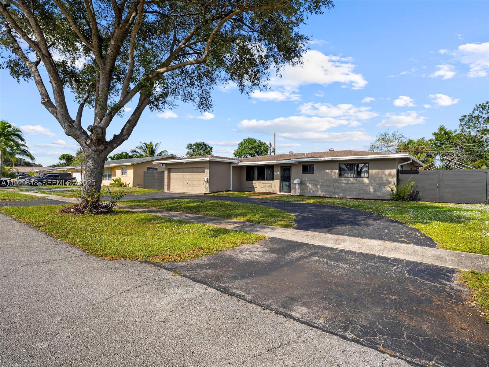 4461 Northwest 6th Street Plantation, FL 33317 - Photo 2 of 30 a front view of house with yard and green space