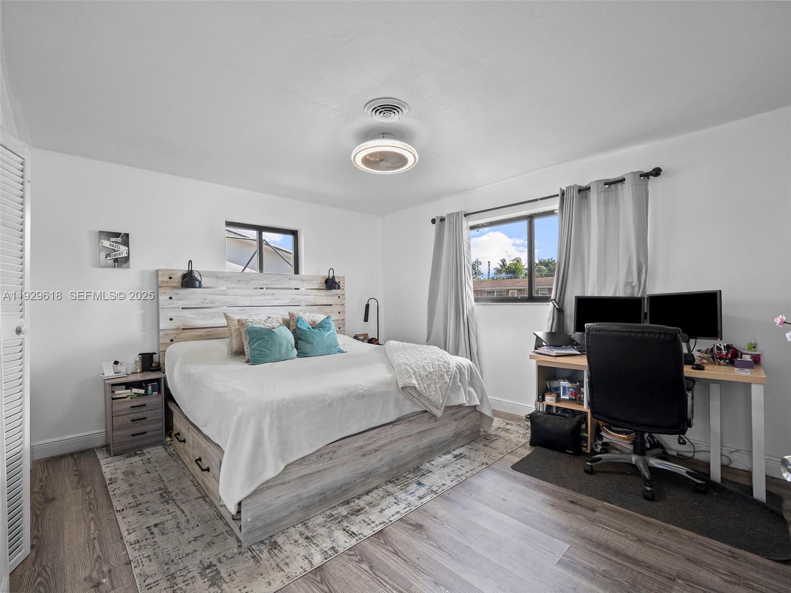 4461 Northwest 6th Street Plantation, FL 33317 - Photo 21 of 30 a bedroom with a bed and wooden floor