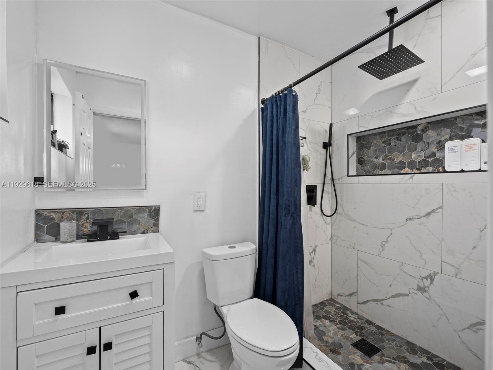 4461 Northwest 6th Street Plantation, FL 33317 - Photo 22 of 30 a bathroom with a toilet sink and shower
