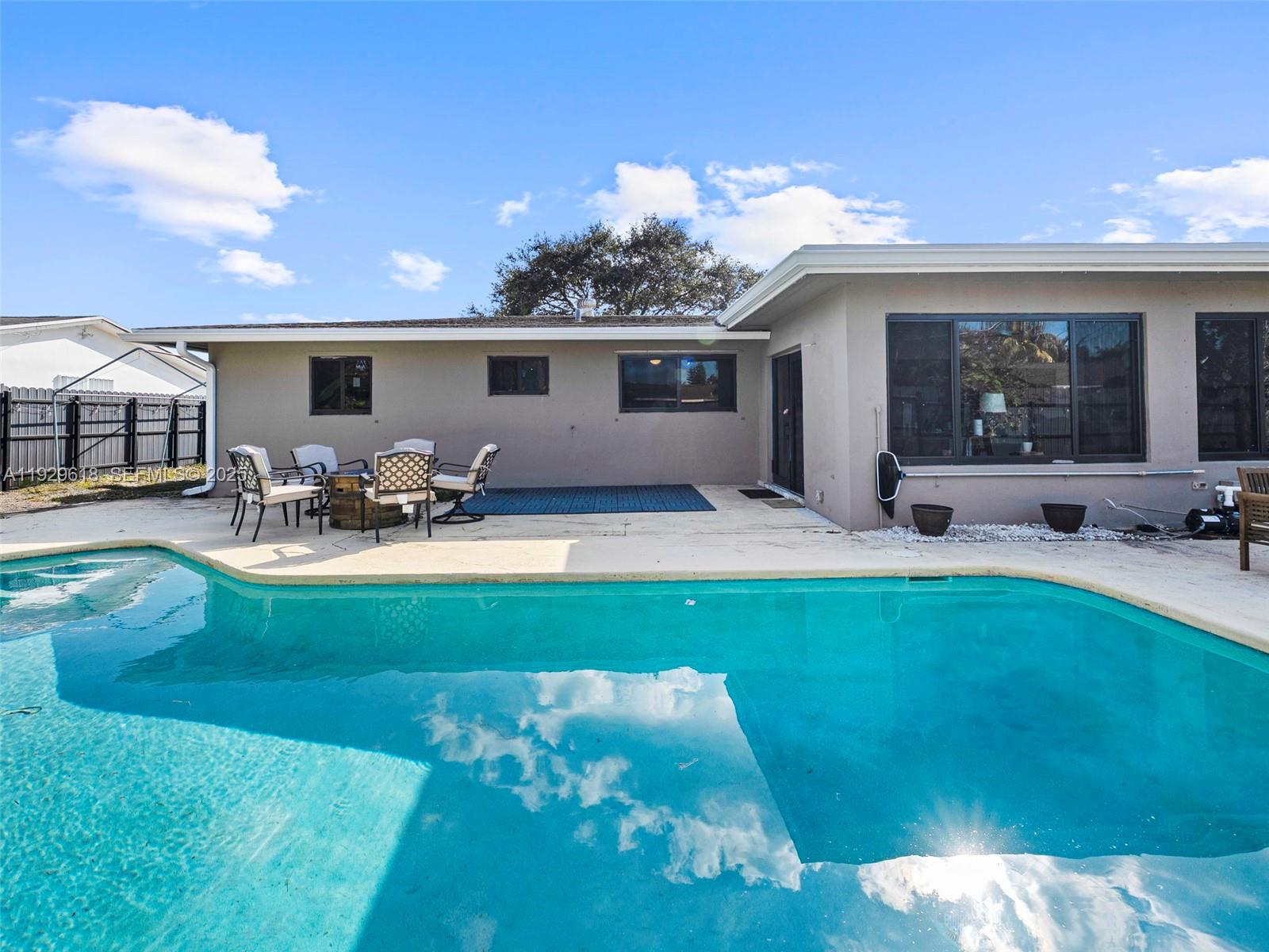 4461 Northwest 6th Street Plantation, FL 33317 - Photo 23 of 30 a view of a house with swimming pool and a yard