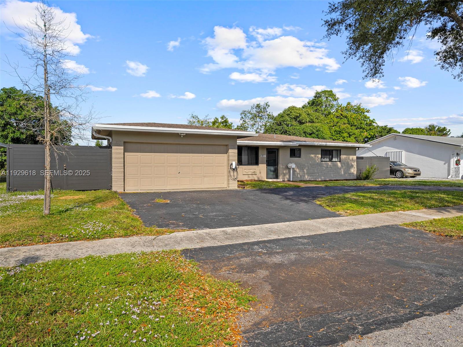 4461 Northwest 6th Street Plantation, FL 33317 - Photo 3 of 30 a view of a house with swimming pool and a yard