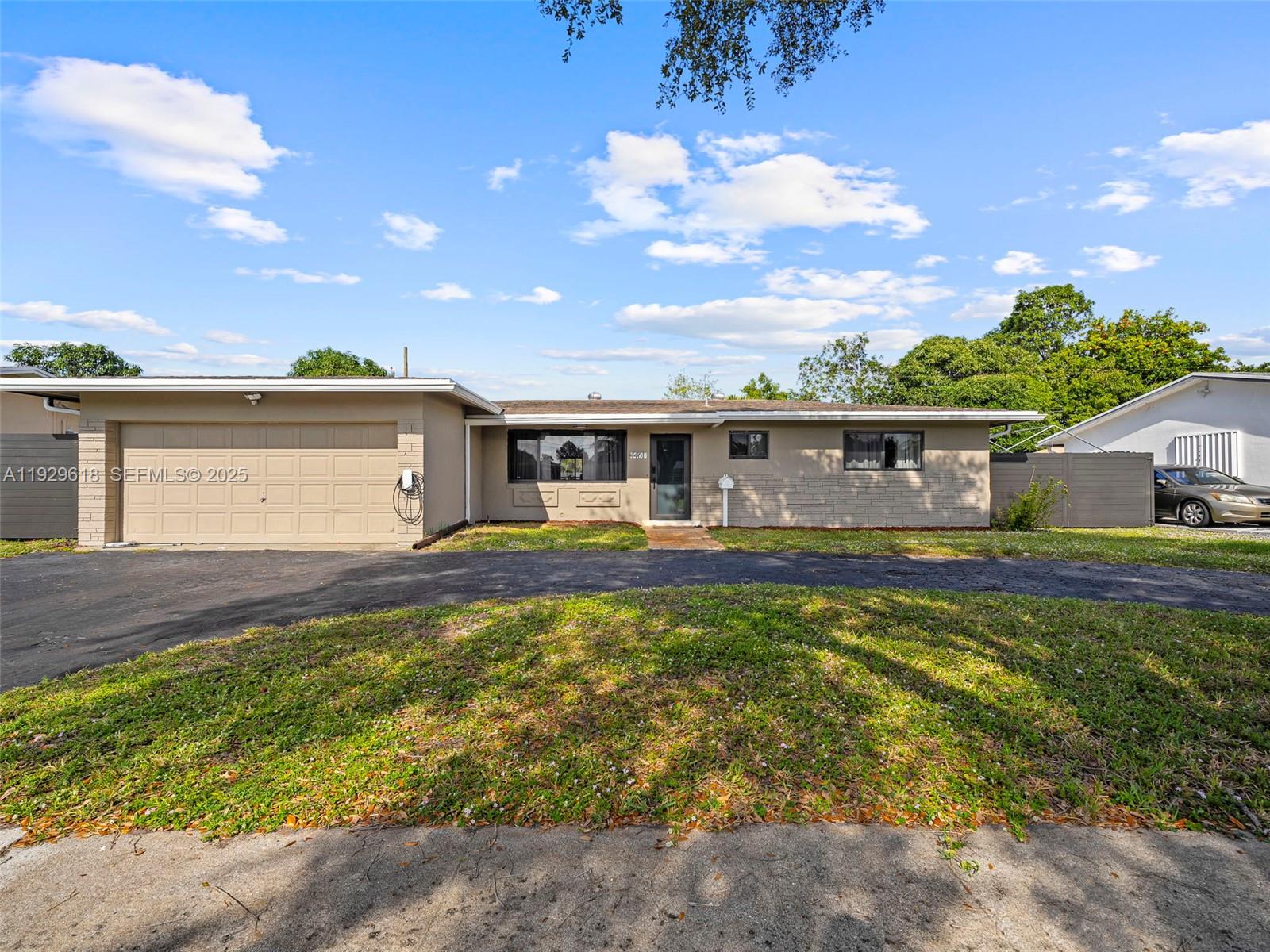 4461 Northwest 6th Street Plantation, FL 33317 - Photo 4 of 30 a front view of a house with a yard