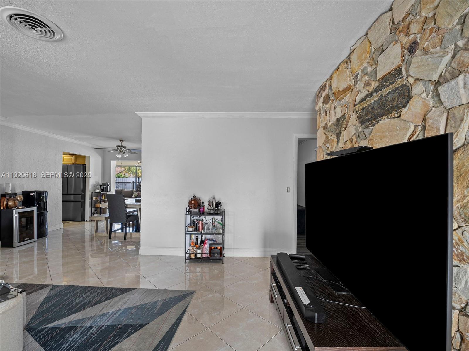 4461 Northwest 6th Street Plantation, FL 33317 - Photo 6 of 30 a living room with furniture and a flat screen tv
