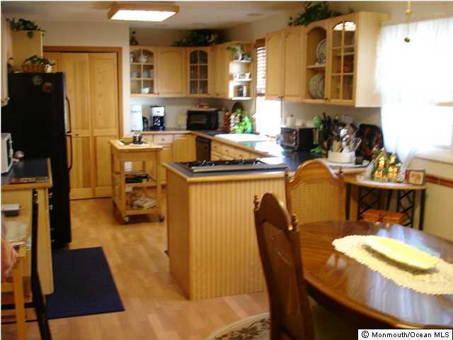 104 Pinewood Road Toms River, NJ 08753 - Photo 2 of 3 a dining room with stainless steel appliances a dining table and chairs