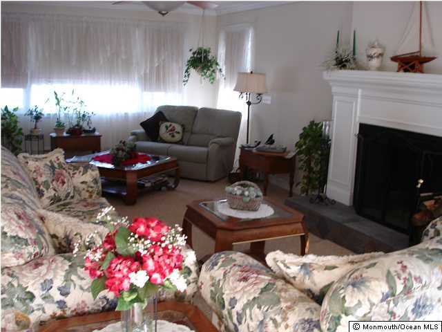 104 Pinewood Road Toms River, NJ 08753 - Photo 3 of 3 a living room with furniture and flowers