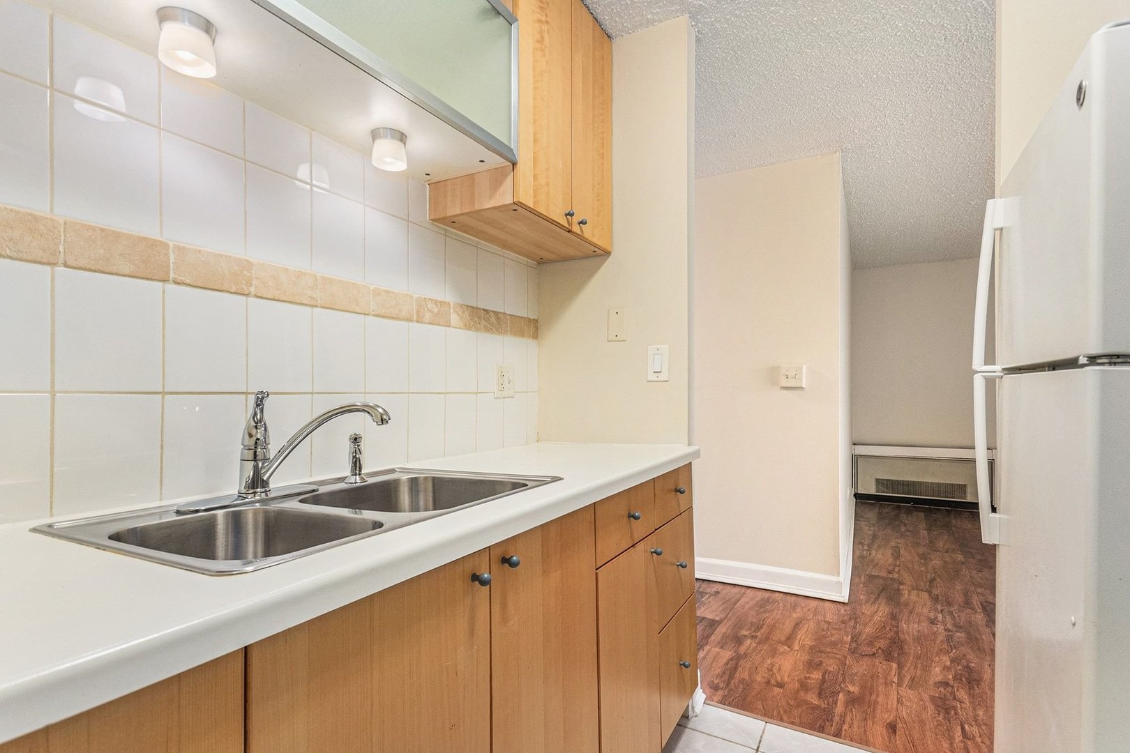 1043 South York Road, Unit 202 Bensenville, IL 60106 - Photo 11 of 19 a kitchen with a sink and a refrigerator