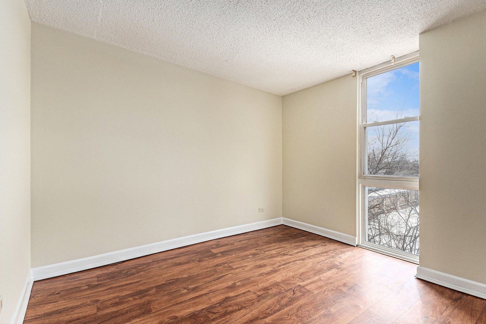 1043 South York Road, Unit 202 Bensenville, IL 60106 - Photo 13 of 19 an empty room with wooden floor and windows