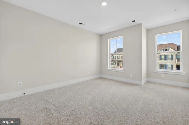 a view of an empty room with windows