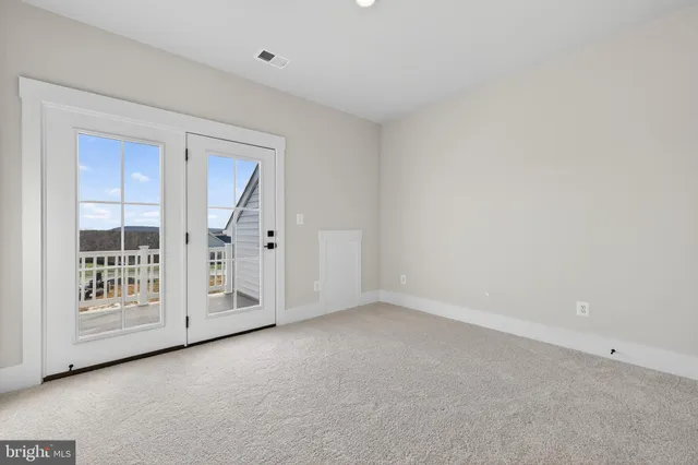 a view of an empty room with windows