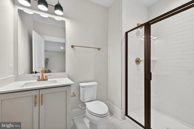 a bathroom with a toilet a sink and a mirror