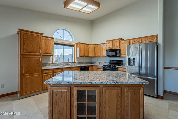 a kitchen with stainless steel appliances a refrigerator and a stove