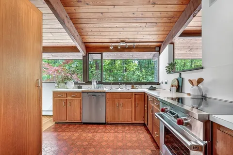 a kitchen with a sink stove and cabinets