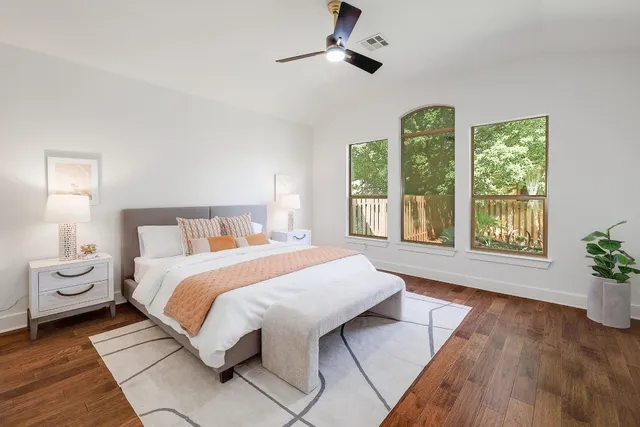 a bedroom with a large bed and a window