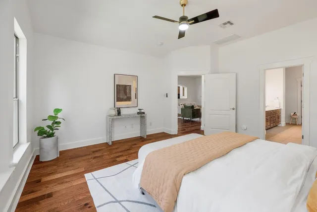 a bedroom with a bed and a potted plant