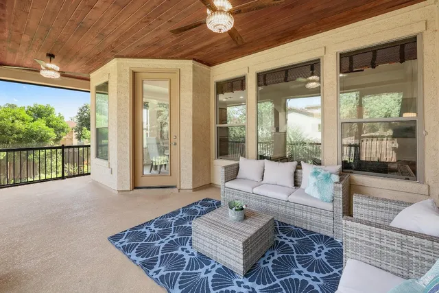 a living room with furniture and a floor to ceiling window