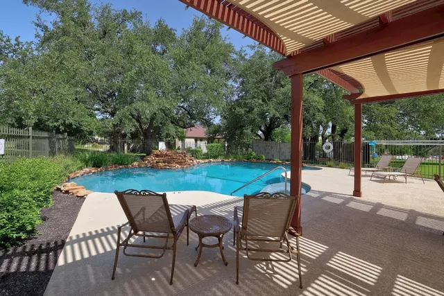 a view of a patio with a table chairs and a backyard