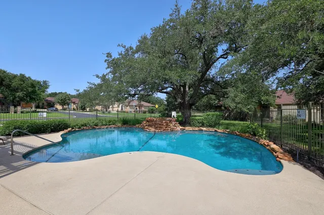 a view of a swimming pool and garden