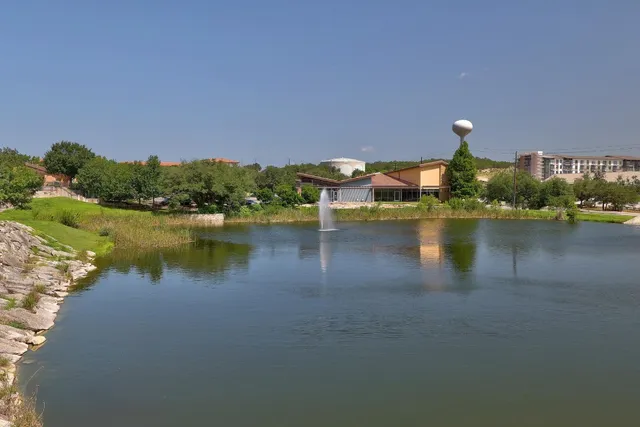 a view of a lake with houses in the back