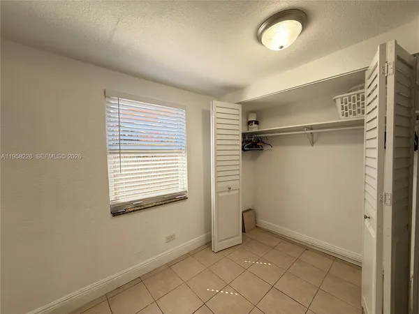a view of a room with rack on the wall and a window
