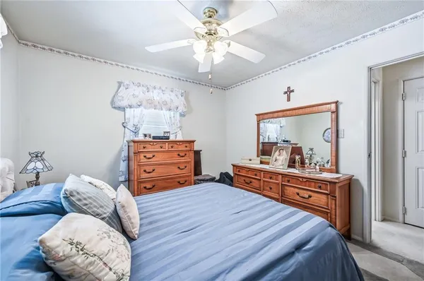 a bed room with a bed and a chandelier