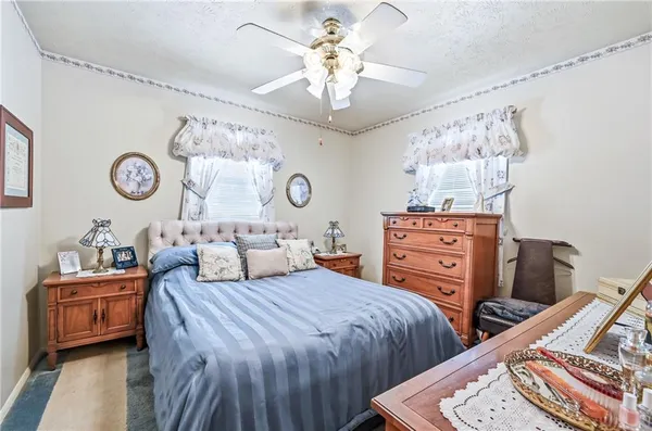 a bedroom with two beds and a chandelier