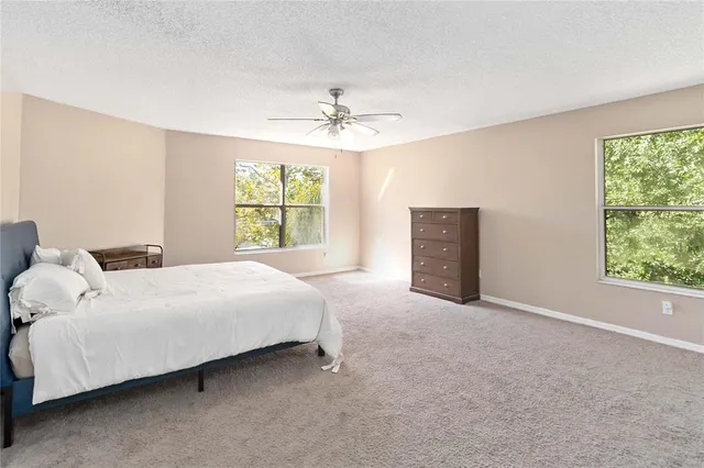 a bed room with a bed and a chandelier