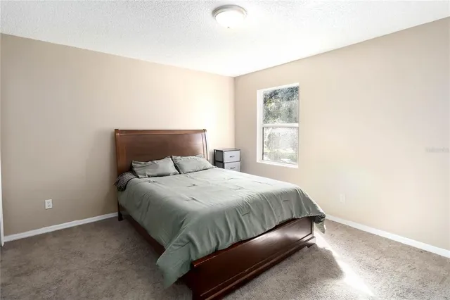 a bedroom with a bed and window