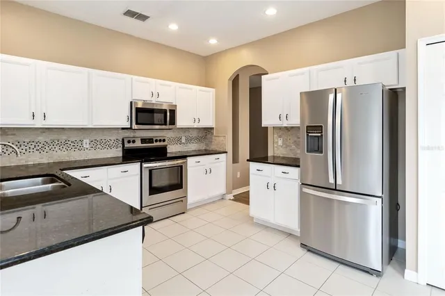 a kitchen with a refrigerator sink and microwave