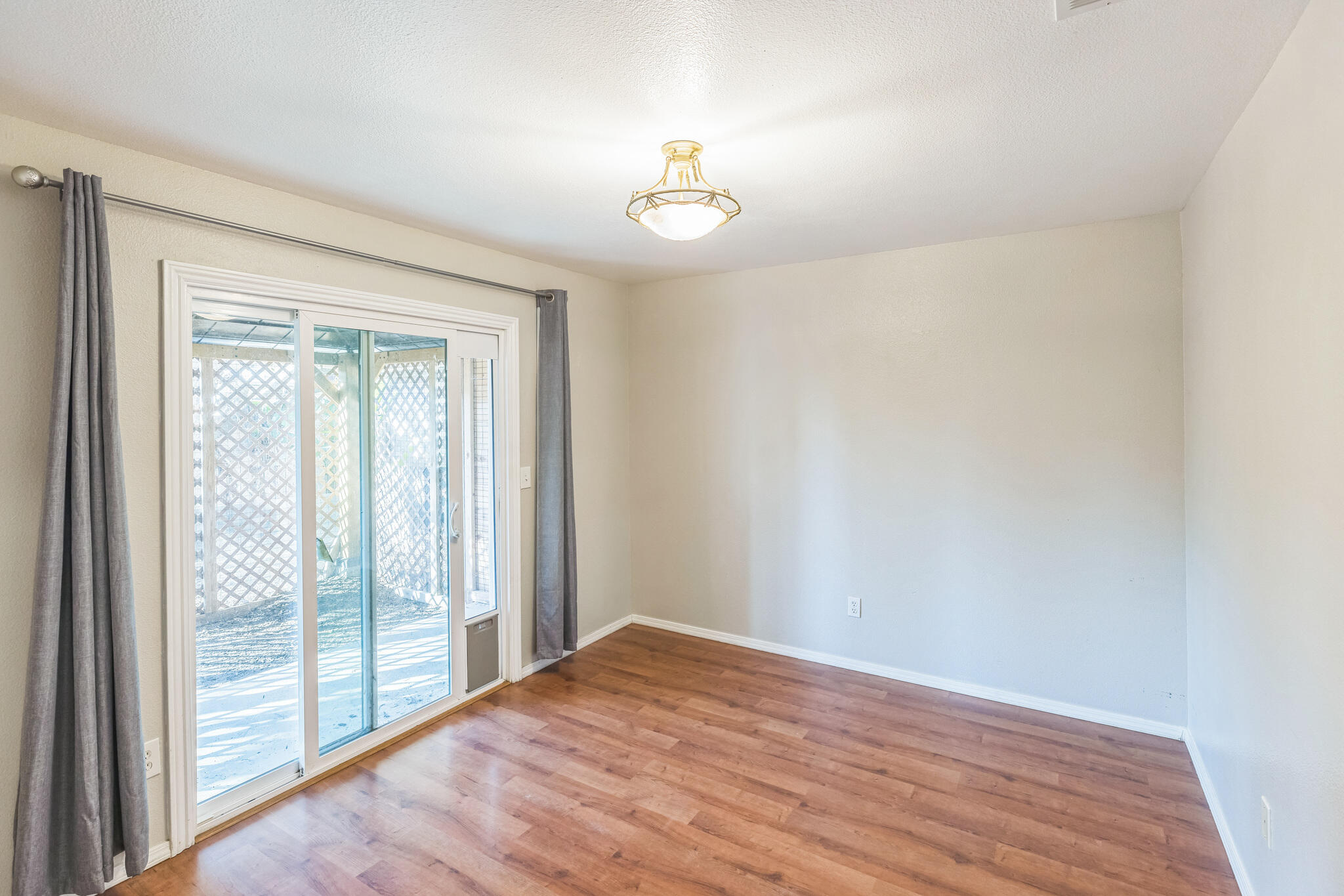 5146 Turnstone Circle Guadalupe, CA 93434 - Photo 12 of 21 a view of an empty room with wooden floor and a window