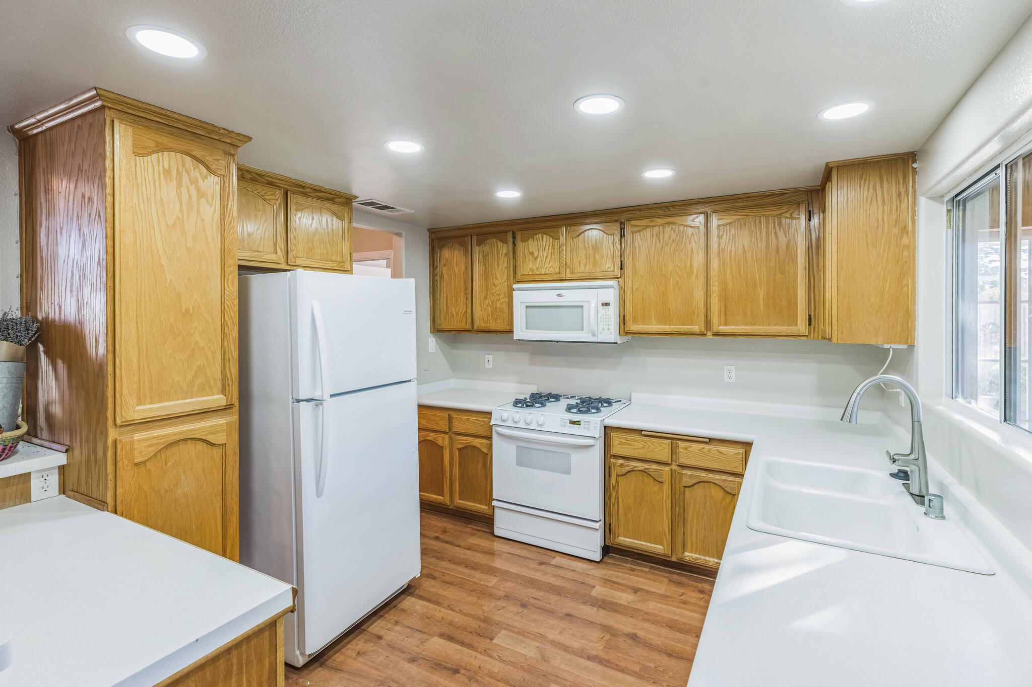 5146 Turnstone Circle Guadalupe, CA 93434 - Photo 5 of 21 a kitchen with a refrigerator a sink and wooden cabinets