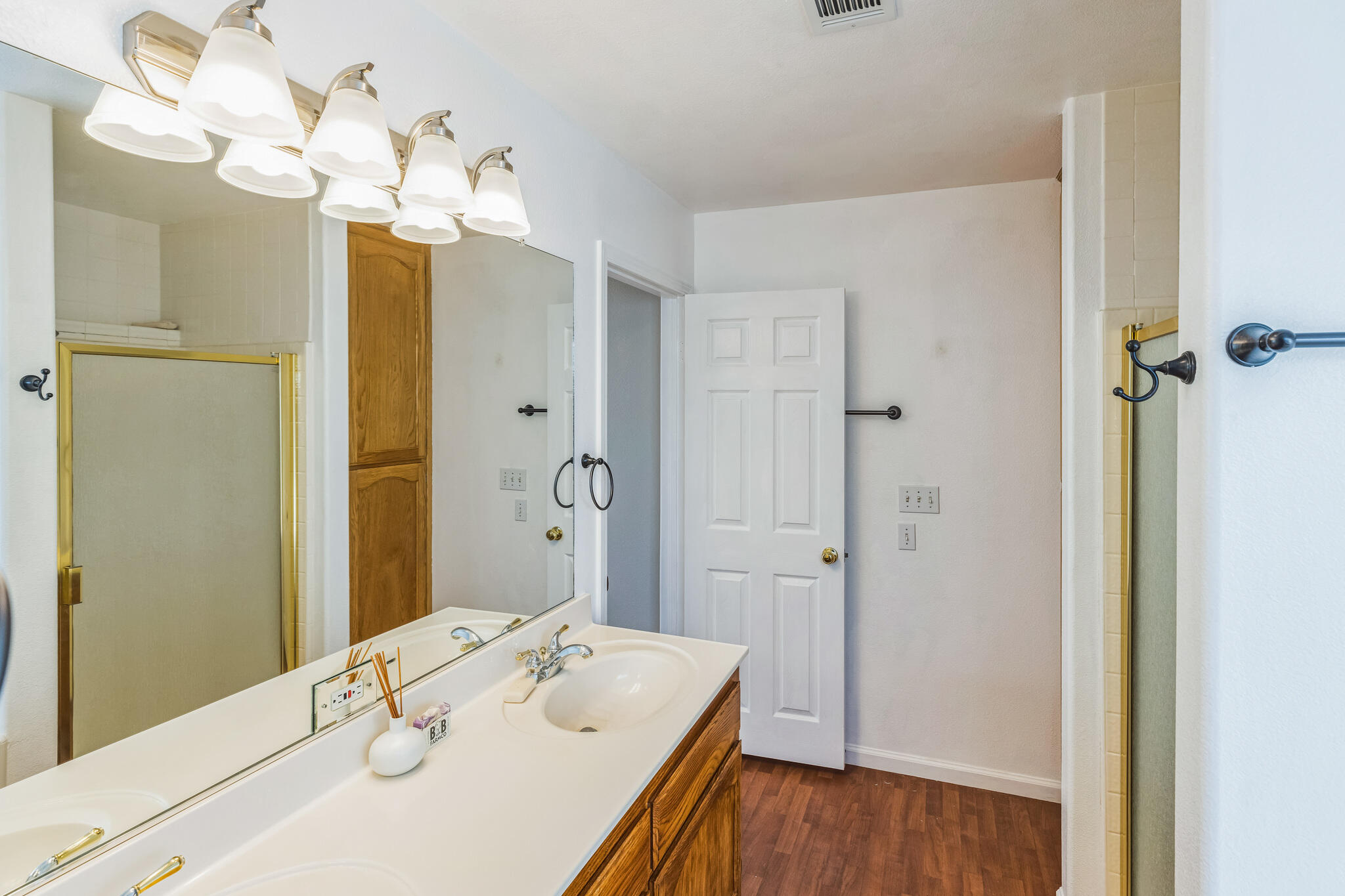 5146 Turnstone Circle Guadalupe, CA 93434 - Photo 9 of 21 a bathroom with a sink vanity granite shower and a mirror