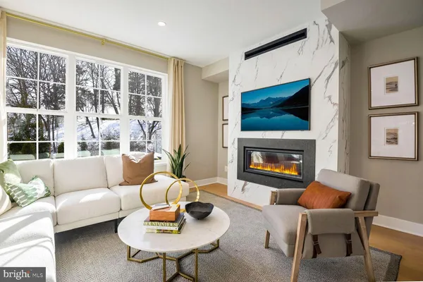 a living room with furniture a rug and a flat screen tv
