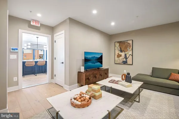 a living room with furniture a rug and a chandelier