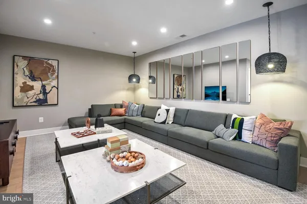 a spacious bedroom with a bed a couch and large windows