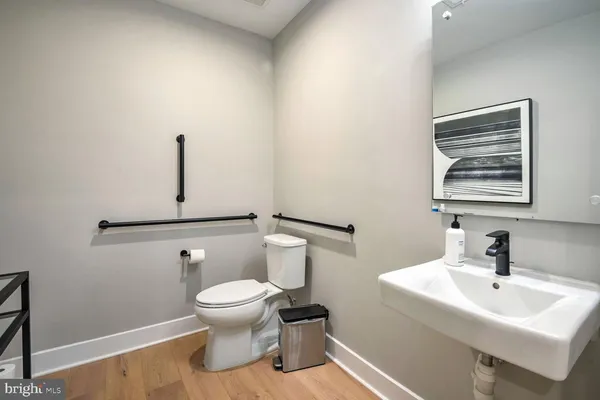 a bathroom with a sink a toilet and shower curtain
