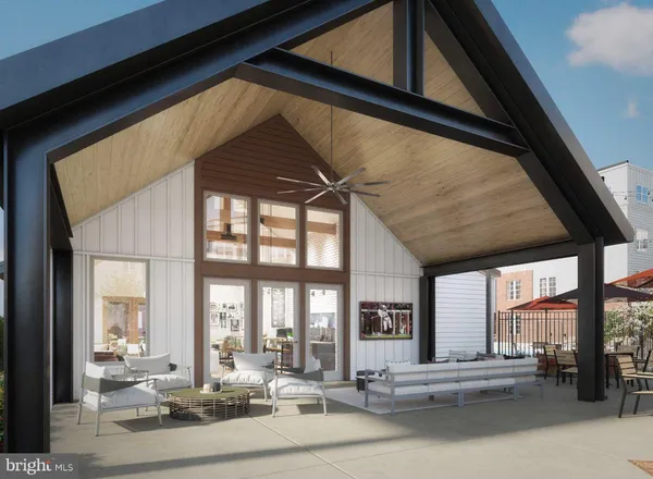 a kitchen with stainless steel appliances kitchen island granite countertop a refrigerator a stove a oven and a dining table with wooden floor