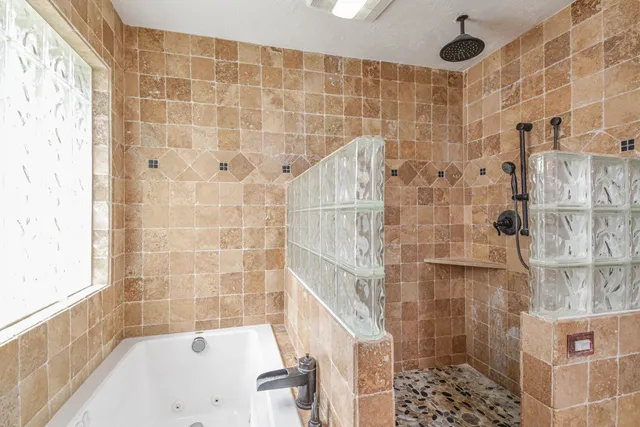 a bathroom with a bathtub and shower