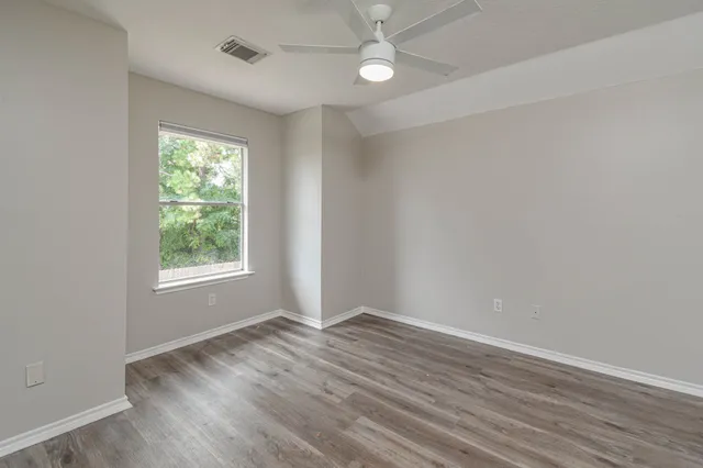 wooden floor in an empty room with a window