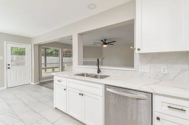 a kitchen with a sink and cabinets
