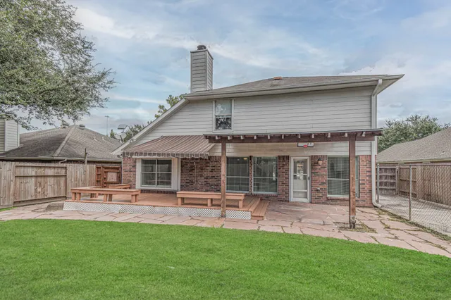 a backyard of a house with table and chairs