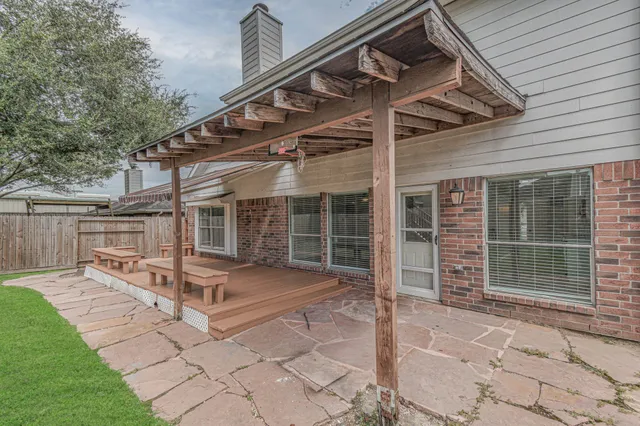 a view of a house with backyard porch and sitting area
