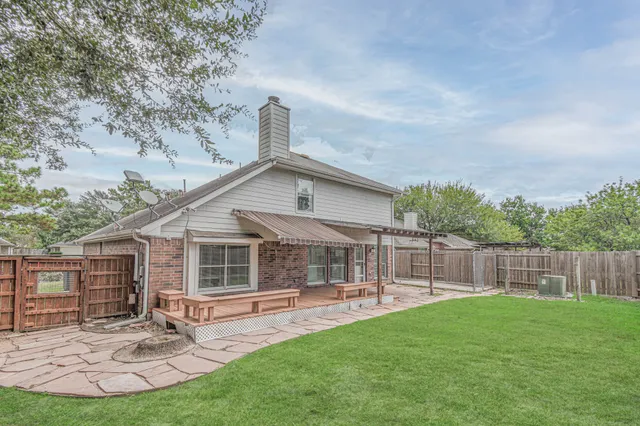 a view of a house with a yard and sitting area