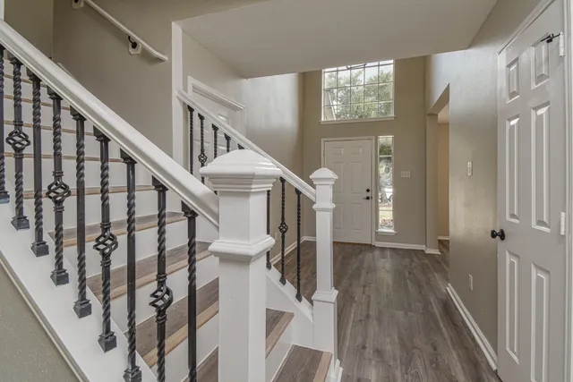 a view of entryway with wooden floor and stairs